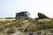 1993 Ford Bronco - This 1992 Ford Bronco navigates a sandy, rocky landscape under a clear sky.