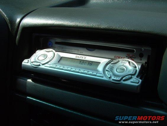 Car dashboard with a Sony CD player and digital clock showing 12:16
