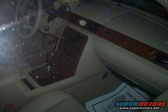 car interior with wood trim, automatic shifter, and dashboard controls