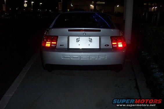 Rear view of a silver 2001 Ford Mustang Cobra with 'COBRA' embossed on the bumper and 'SVT' badge on the left taillight