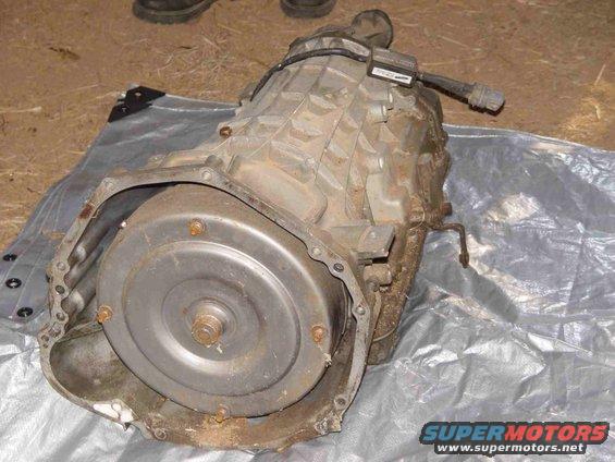 Automatic transmission part on a tarp, showing torque converter and casing