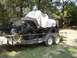 1995 Ford Bronco - A 1978 Ford Bronco, modified with large tires, is loaded onto a trailer.