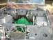 1995 Ford Bronco - The engine bay of a vehicle is shown disassembled, with various parts and wiring exposed.
