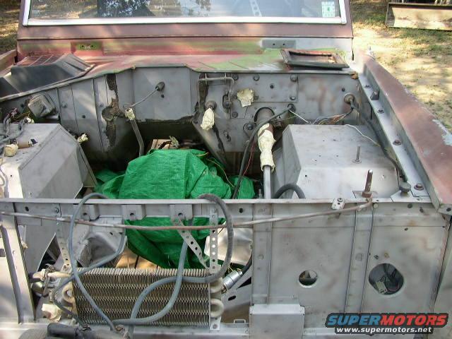 1995 Ford Bronco engine bay with green tarp covering engine components
