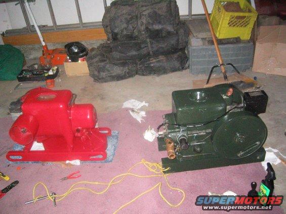 Red and green engines sit on a pink carpeted floor with tools nearby