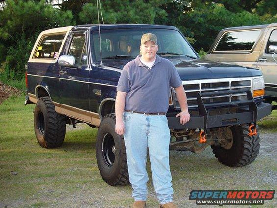Blue 1989 Ford Bronco with tan top and aftermarket bumper