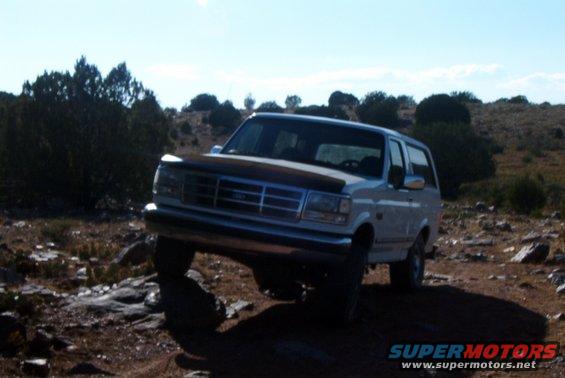 White 1995 Ford Bronco on rocky trail