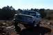 1995 Ford Bronco - This 1995 Ford Bronco navigates a , rocky path under a clear blue sky.