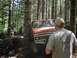 1993 Ford Bronco - Off-road vehicle navigating a tight spot between trees on a wooded trail.