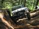 1993 Ford Bronco - This 1979 Ford Bronco navigates a challenging dirt trail, equipped with a winch and brush guard for off-road adventures.
