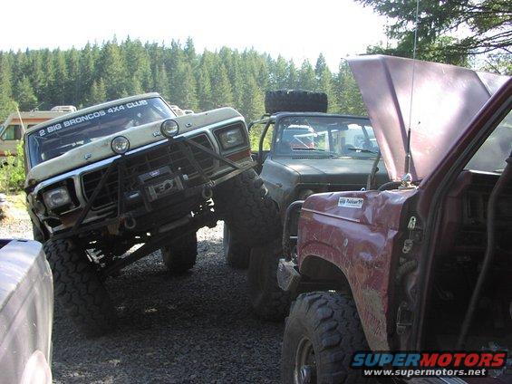 Modified 1978 Ford Bronco with custom bumper and winch, parked with other trucks
