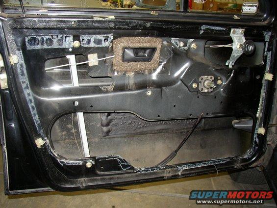 Car door interior with window mechanism visible