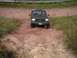 1994 Ford Bronco - This 1994 Ford Bronco navigates a challenging off-road course, its front grille and body style clearly identifiable.