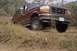 1994 Ford Bronco - This 1994 Ford Bronco is captured in a three-quarter front view while navigating rough terrain.