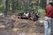1994 Ford Bronco - Off-roading in a Jeep Wrangler, navigating a challenging muddy path.