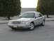 2004 Ford Crown Victoria - A silver sedan is parked outdoors with trees in the background.