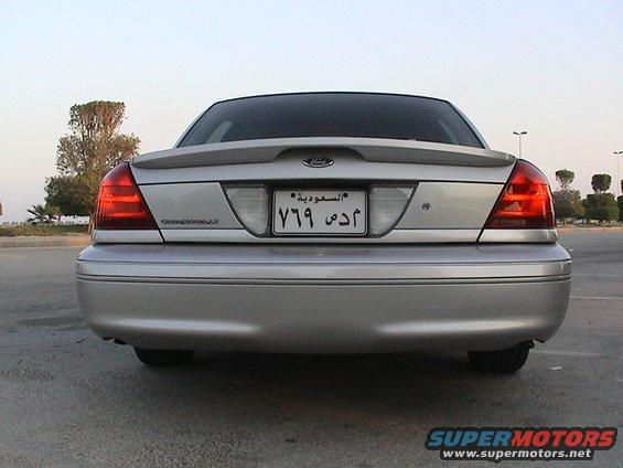 Rear view of a silver 2004 Ford Crown Victoria with a spoiler and Saudi license plate