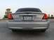 2004 Ford Crown Victoria - The rear of a silver sedan is shown, a spoiler and a license plate with Arabic text.