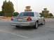 2004 Ford Crown Victoria - Rear view of a silver 2004 Ford Crown Victoria sedan parked in a lot.
