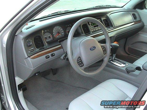 Interior of a 2004 Ford Crown Victoria showing dashboard, steering wheel, and seats