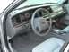 2004 Ford Crown Victoria - The interior of a 2004 Ford Crown Victoria features a gray dashboard, steering wheel, and light-colored leather seats.