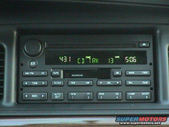 Dashboard radio with green digital display showing time and CD track information