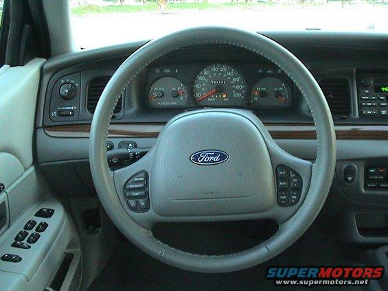 Interior dashboard of a 2004 Ford Crown Victoria showing the steering wheel and instrument cluster