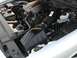 2004 Ford Crown Victoria - Close-up view of a vehicle's engine bay, showing various mechanical parts and fluid reservoirs.