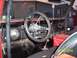 1971 Ford Bronco - The interior of a 1971 Ford Bronco features a custom steering wheel and dashboard.