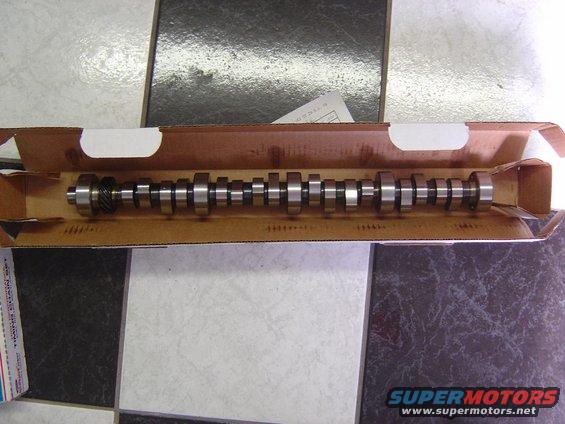 Camshaft in a cardboard box, with a gear on one end