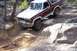 1982 Ford Bronco - This 1982 Ford Bronco is shown tackling a challenging off-road course with large rocks.