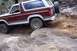 1982 Ford Bronco - Ford Bronco tackling a challenging off-road course with steep inclines and loose terrain.