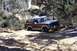 1982 Ford Bronco - This Ford Bronco is tackling a challenging off-road course with rough terrain and dense vegetation.