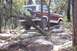 1982 Ford Bronco - This 1982 Ford Bronco is shown traversing a challenging, off-road path through a forest.