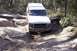1982 Ford Bronco - This vehicle is navigating a challenging rocky terrain on a wooded trail.
