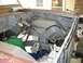 1995 Ford Bronco - The engine bay of a vehicle shows various hoses, wiring, and mechanical components during what appears to be a restoration or repair proces…