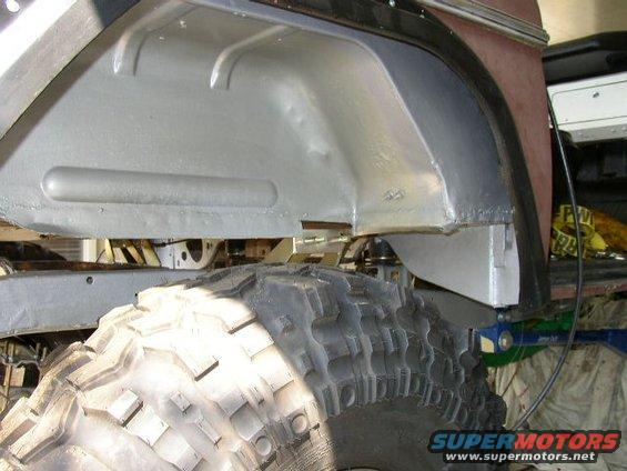 close-up of a large off-road tire and the inside of a vehicle's wheel well