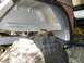 1995 Ford Bronco - The underside of a vehicle, focusing on the wheel well and a large tire, with some repair work visible.