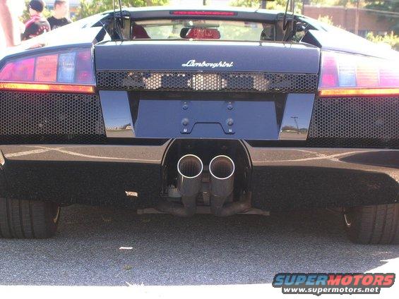 Black Lamborghini rear view with quad exhaust pipes