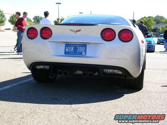 Silver Corvette with quad exhaust pipes and a Michigan license plate
