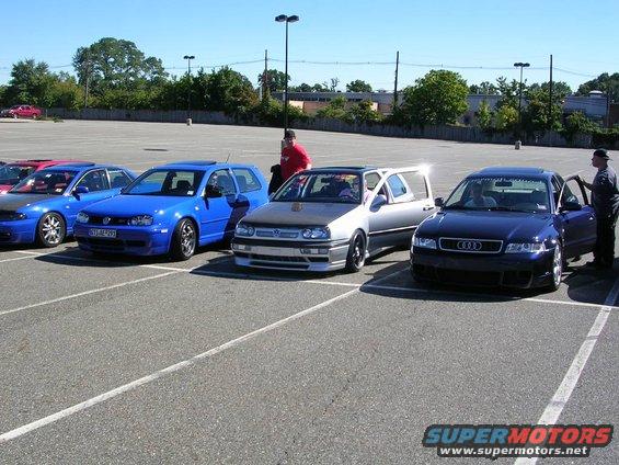 Silver 1996 Volkswagen GTI with carbon fiber hood and open driver door