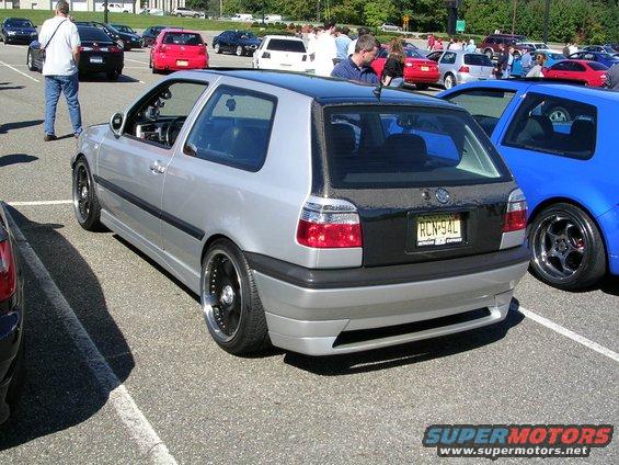 Silver 1996 Volkswagen GTI with black roof and custom wheels parked in a lot