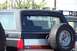 1990 Ford Bronco - This Ford Bronco has a spare tire mounted on the rear door and a website sticker on the back window.