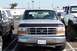 1990 Ford Bronco - This Ford F-Series truck, likely from the early 1990s, is parked between other vehicles.