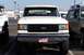 1990 Ford Bronco - Front view of a white 1990 Ford Bronco, parked next to another vehicle.