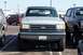 1990 Ford Bronco - This lifted Ford Bronco is parked in a lot with other vehicles. The grille and headlights suggest it is from the late 1980s.