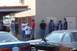 1990 Ford Bronco - A group of men gather outside a building on a sunny day, with several vehicles visible.