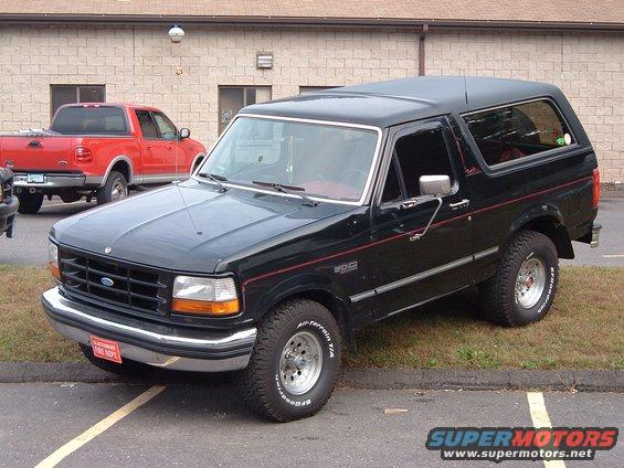 Black 1993 Ford Bronco with red pinstriping and a fire department plate