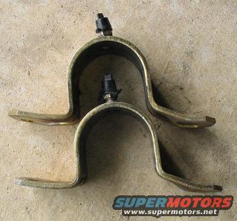 Two metal brackets with bolts on a concrete surface. Supermotors.net logo visible