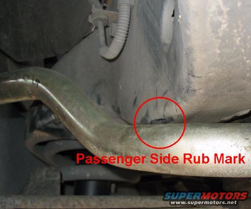 Underbody suspension part with a red circle highlighting a passenger side rub mark